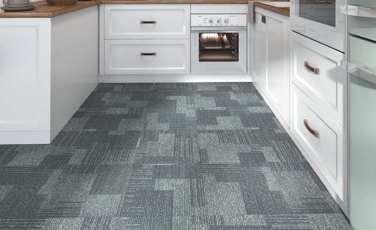 A contemporary kitchen displaying grey carpeting and white cabinets, ideal for a Sacramento residence.