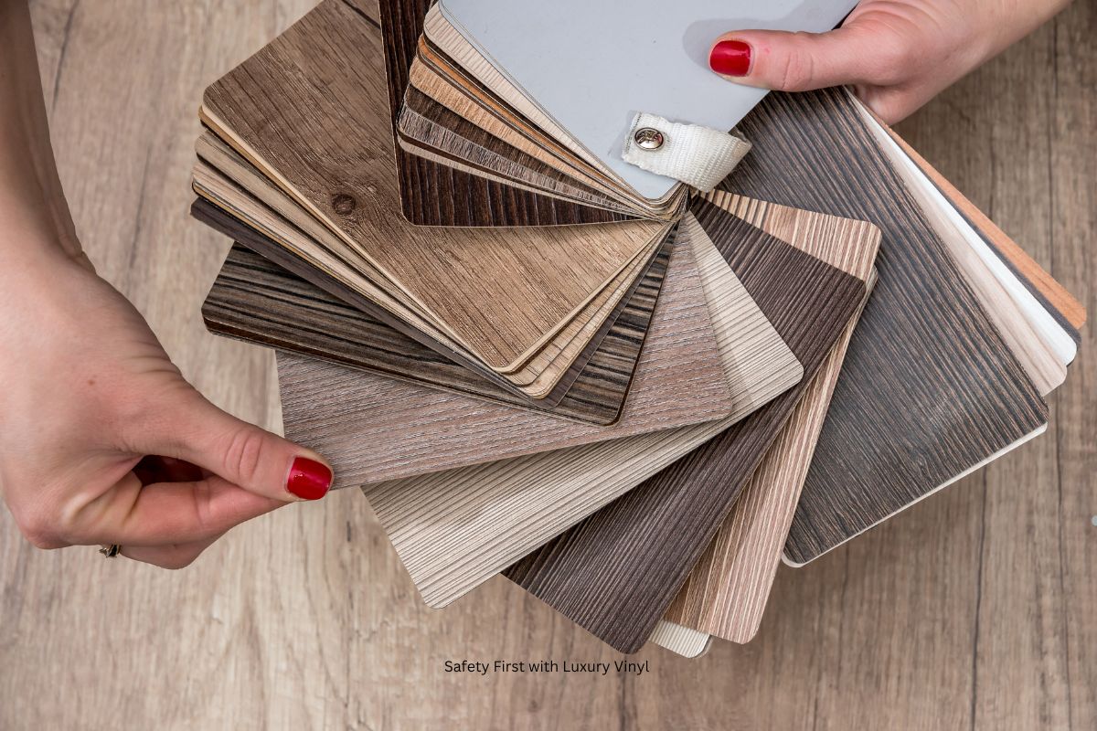 A person's hands holding a stack of various luxury vinyl flooring samples in different wood finishes.